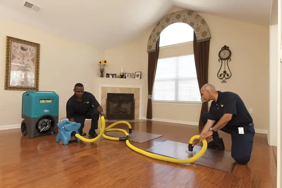 Technician extracting standing water from a Santa Clarita floor